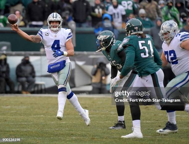 Dallas Cowboys quarterback Dak Prescott throws on the run as Philadelphia Eagles defensive ends Vinny Curry and Steven Means chase at Lincoln...