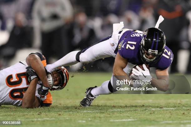 Wide Receiver Michael Campanaro of the Baltimore Ravens is tackled after a catch by linebacker Hardy Nickerson of the Cincinnati Bengals in the third...