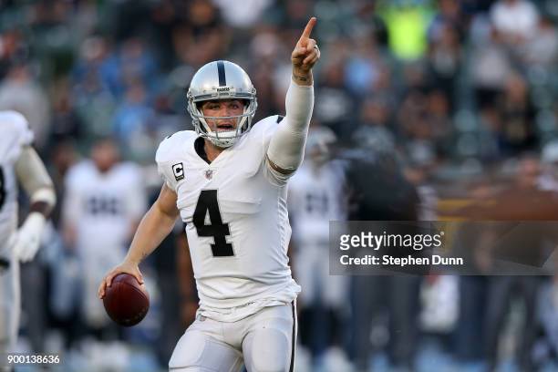 Derek Carr of the Oakland Raiders directs his team before throwing the ball during the second half of the game against the Los Angeles Chargers at...