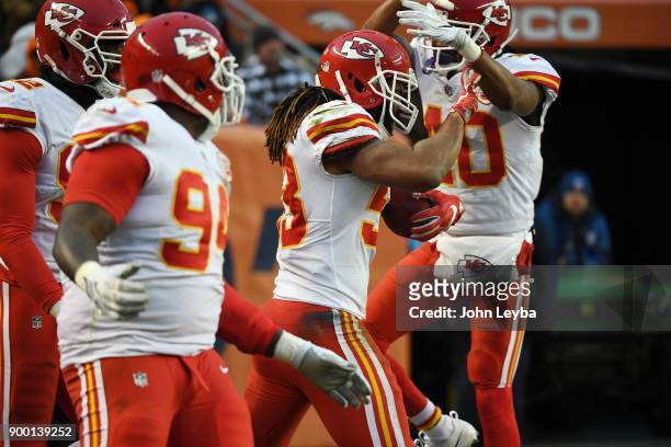 Kansas City Chiefs inside linebacker Ramik Wilson celebrates his touchdown with cornerback Keith Reaser after picking up a fumble by Denver Broncos...