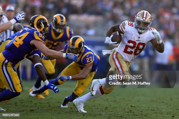 Carlos Hyde of the San Francisco 49ers eludes Bryce Hager, Isaiah Johnson and Carlos Thompson of the Los Angeles Rams during the second half of a...