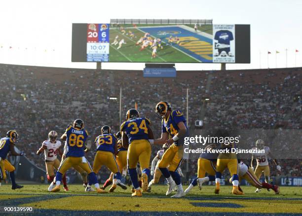 Sean Mannion of the Los Angeles Rams hands off the ball to running back Malcolm Brown of the Los Angeles Rams during the third quarter against San...