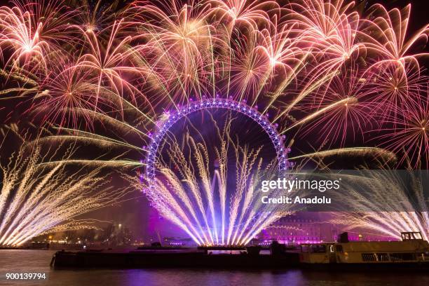 Fireworks light up the sky above the London Eye during the new year celebrations in London, United Kingdom on January 01, 2018.