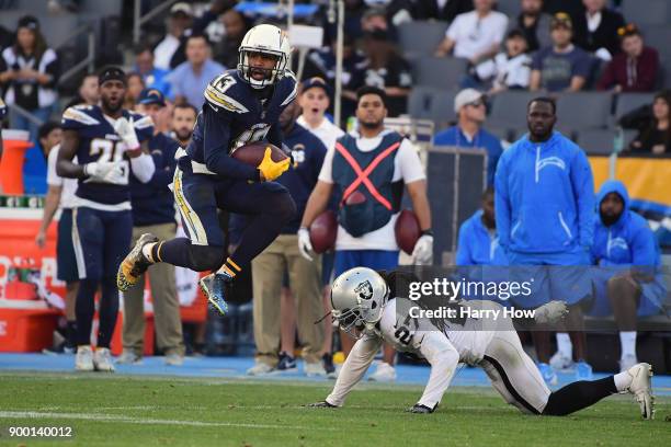 Keenan Allen of the Los Angeles Chargers makes a reception against Reggie Nelson of the Oakland Raiders during the second quarter of the game at...