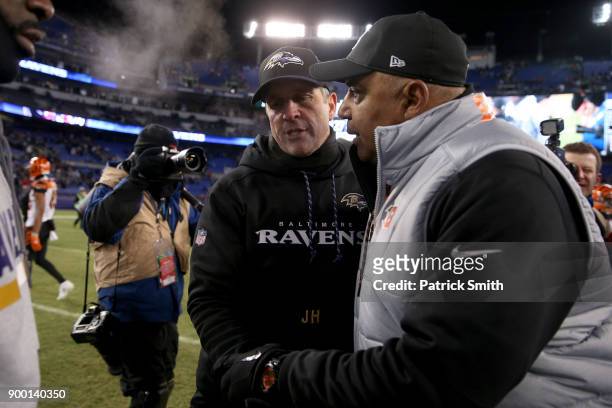 Head Coach John Harbaugh of the Baltimore Ravens and head coach Marvin Lewis of the Cincinnati Bengals shake hands after the Cincinnati Bengals 31-27...