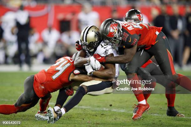 Kwon Alexander and Brent Grimes of the Tampa Bay Buccaneers tackle Michael Thomas of the New Orleans Saints in the fourth quarter of a game at...