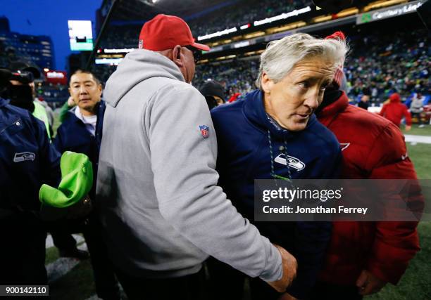 Seattle Seahawks head coach Pete Carroll walks away after greeting Arizona Cardinals head coach Bruce Arians after the game at CenturyLink Field on...