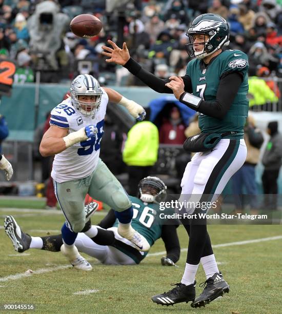 Dallas Cowboys defensive end Tyrone Crawford flattens Philadelphia Eagles offensive tackle Will Beatty on his way to quarterback Nate Sudfeld during...