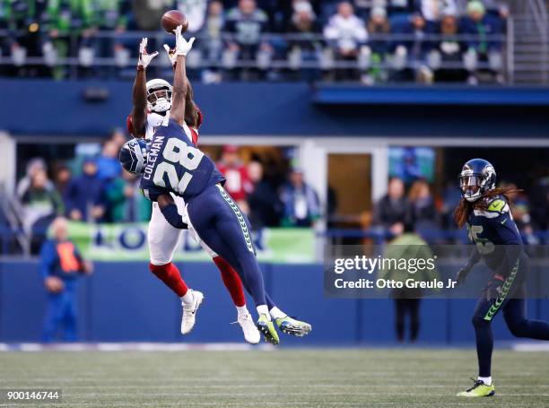 Cornerback Justin Coleman of the Seattle Seahawks tips away the pass to wide receiver Jaron Brown of the Arizona Cardinals in the fourth quarter at...