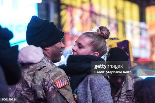 Couple share an embrace in Times Square ahead of the New Year's Eve celebration on December 31, 2017 in New York City.