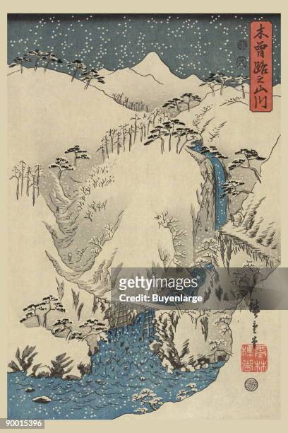Print shows mountains and river along the Kiso Road during a winter snow storm. Part 3 of a tryptich by Ando Hiroshige started in 1857