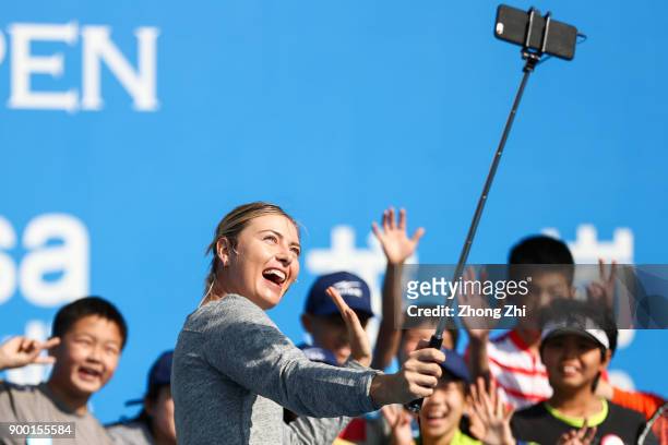 Maria Sharapova of Russia attends Kids Day and takes selfie with kids during Day 1 of 2018 WTA Shenzhen Open at Longgang International Tennis Center...