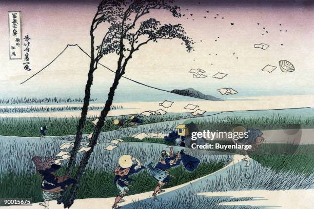Paper fly's as travelers pass along a road