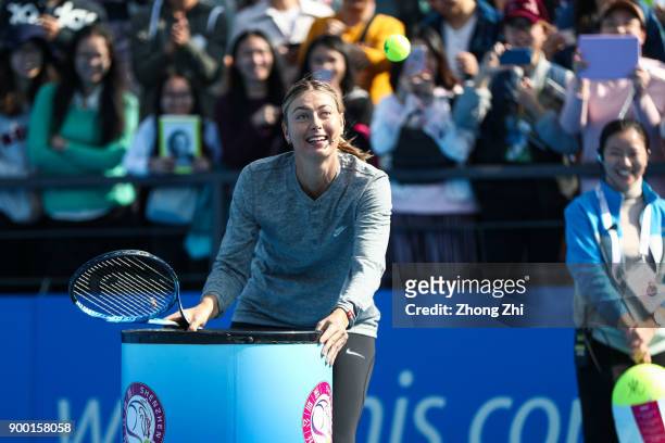 Maria Sharapova of Russia attends Kids Day during Day 1 of 2018 WTA Shenzhen Open at Longgang International Tennis Center on December 31, 2017 in...