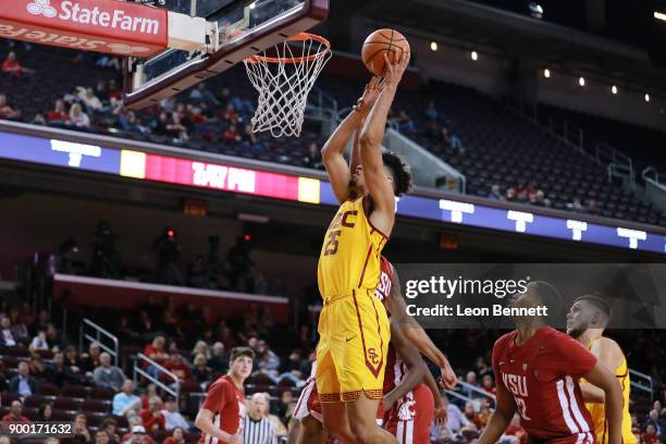 Bennie Boatwright of the USC Trojans handles the ball against Arinze Chidom of the Washington State Cougars during a PAC12 college basketball game at...