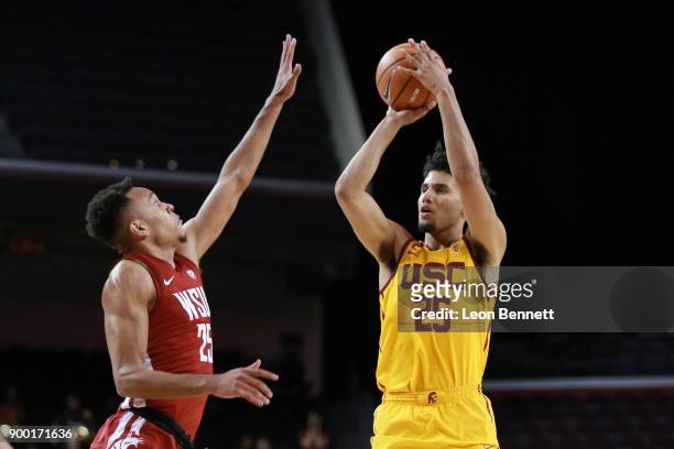 Bennie Boatwright of the USC Trojans handles the ball against Arinze Chidom of the Washington State Cougars during a PAC12 college basketball game at...