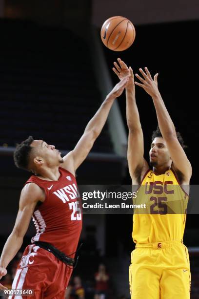 Bennie Boatwright of the USC Trojans handles the ball against Arinze Chidom of the Washington State Cougars during a PAC12 college basketball game at...