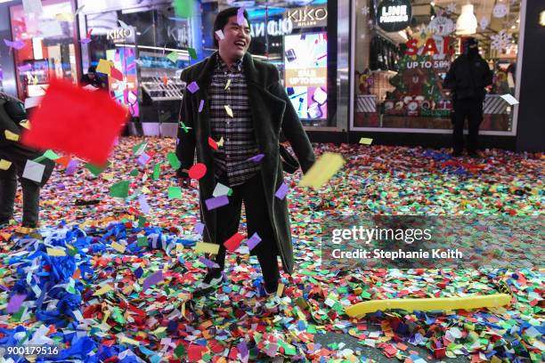 People throw confetti on New Year's Eve in Times Square on January 1, 2018 in New York City.