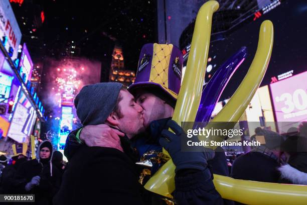 People kiss on New Year's Eve in Times Square on January 1, 2018 in New York City.