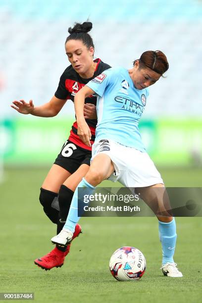 Yukari Kinga of Melbourne City and Alix Roberts of the Wanderers compete for the ball during the round nine W-League match between the Western Sydney...