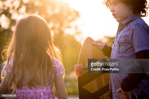 brother and sister skateboarding. - baldwin brothers stock pictures, royalty-free photos & images