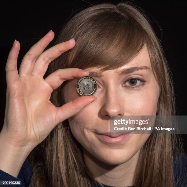 Alex Powell from the Royal Mint, Llantrisant, Wales, holds a &pound;2 coin from the Royal Mint featuring a Frankenstein design commemorating 200...