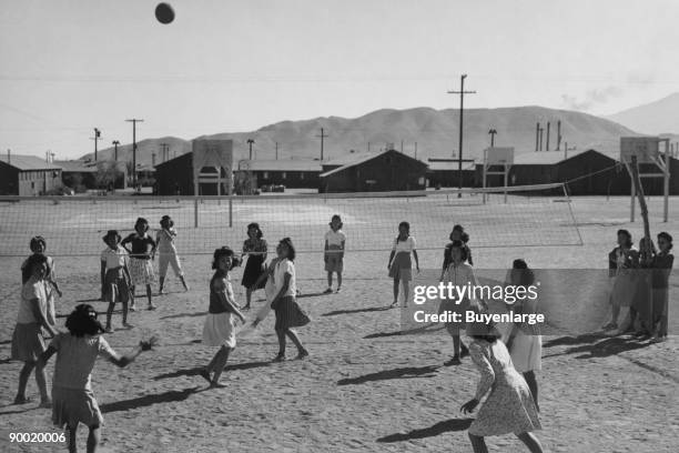 Women playing volleyball, one-story buildings and mountains in the background. Ansel Easton Adams was an American photographer, best known for his...