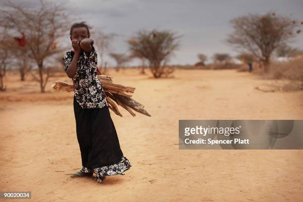 Girl walks home with fire wood in Dadaab, the world�s biggest refugee complex August 22, 2009 in Dadaab, Kenya. The Dadaab refugee complex in...