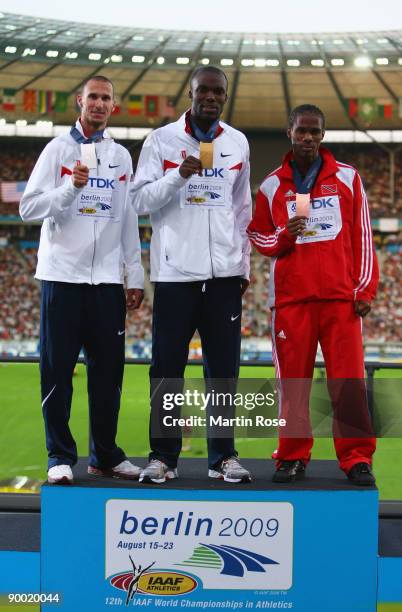 Jeremy Wariner of United States receives the silver medal, Lashawn Merritt of United States the gold medal and Renny Quow of Trinidad and Tobago the...