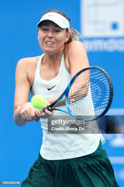 Maria Sharapova of Russia returns a shot during the match against Mihaela Buzarnescu of Romania during Day 2 of 2018 WTA Shenzhen Open at Longgang...