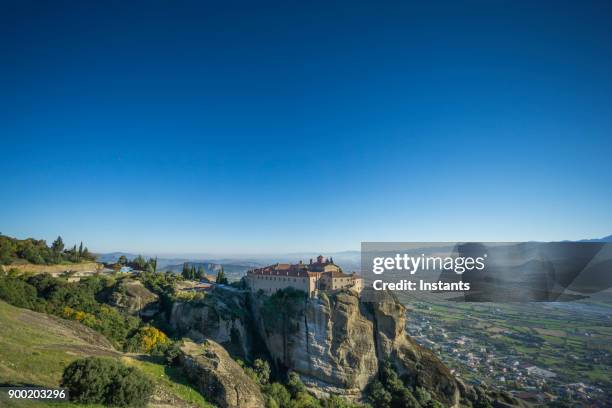 meteora, view at one of the monasteries in kalambaka, greek thessaly plain. - meteora greece stock pictures, royalty-free photos & images