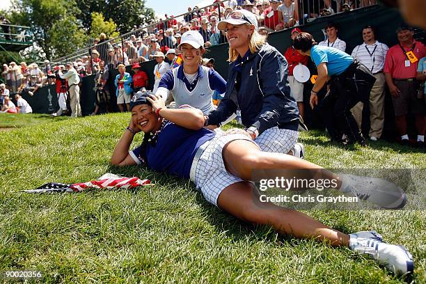 Michelle Wie left, Assistant Captain Kelly Robbins and Christina Kim of the U.S. Team sit on the 14th green after defeating Helen Alfredsson and...