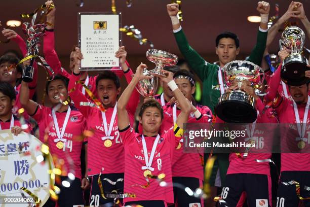 Players of Cerezo Osaka celebrate as captain Yoichiro Kakitani lifts the trophy after the 97th All Japan Football Championship final between Cerezo...