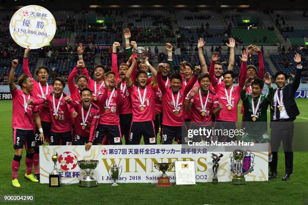 Players of Cerezo Osaka celebrate as captain Yoichiro Kakitani lifts the trophy after the 97th All Japan Football Championship final between Cerezo...