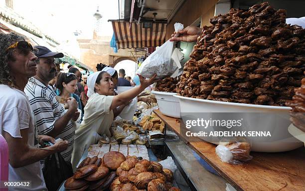 People are seen buying Moroccan pastries on the first day of the holy month of Ramadan in Rabat on August 22, 2009. Muslims entered the fasting and...