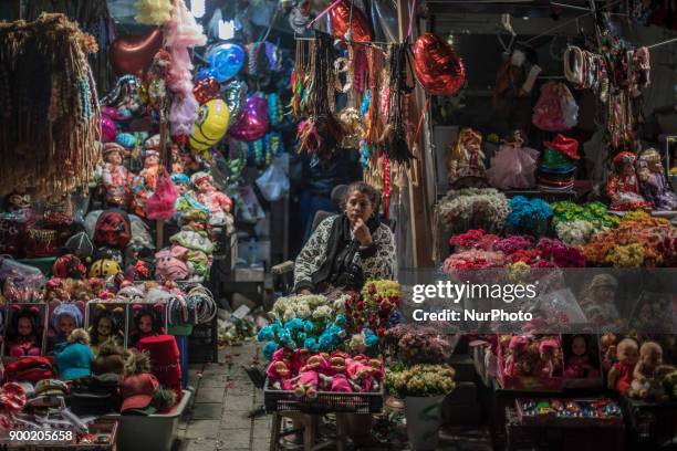 Turkish woman sells flowers to people in Taksim Square in Istanbul on the last night of 2017