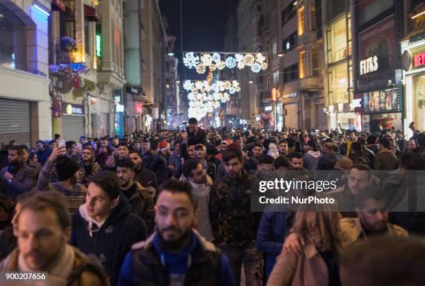 Revellers bid farewell to 2017 as they gather to celebrate New Years in Istanbul on December 31, 2017. Turkey arrested on December 31 more suspected...