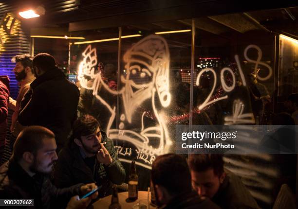 Turkish citizens celebrate in the Taksim district of Istanbul on the last night of 2017. On this day of last year 39 people were killed in an armed...