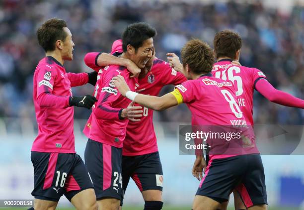 Japanese J-League club Cerezo Osaka midfielder Kazuya Yamamura celebrates his goal with teammates during the Emperor's Cup football final between...