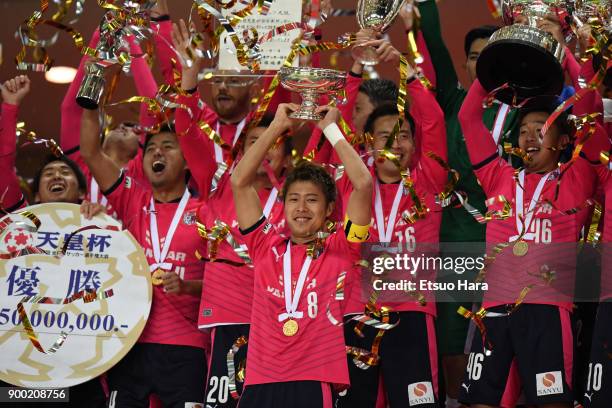 Players of Cerezo Osaka celebrate their victory as captain Yoichiro Kakitani lifts the trophy after the 97th All Japan Football Championship final...