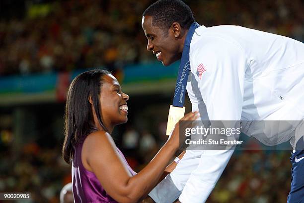 Jesse Owen's granddaughter Marlene Dortch presents Dwight Phillips of United States with the gold medal during the medal ceremony for the men's Long...