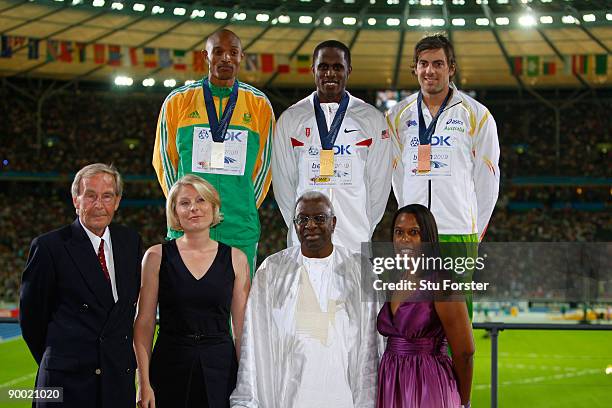 Godfrey Khotso Mokoena of South Africa receives the silver medal, Dwight Phillips of United States the gold medal and Mitchell Watt of Australia the...