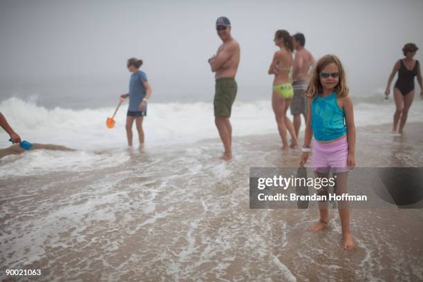 Beachgoers watch large waves crash on Lighthouse Beach, though the ocean is closed to swimming, on August 22, 2009 in Chatham, Massachusetts. A...