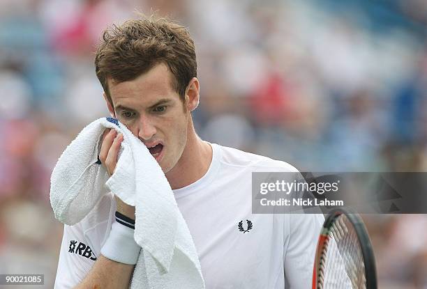 Andy Murray of Great Britain wipes sweat from his face in his semi final loss to Roger Federer of Switzerland during day six of the Western &...