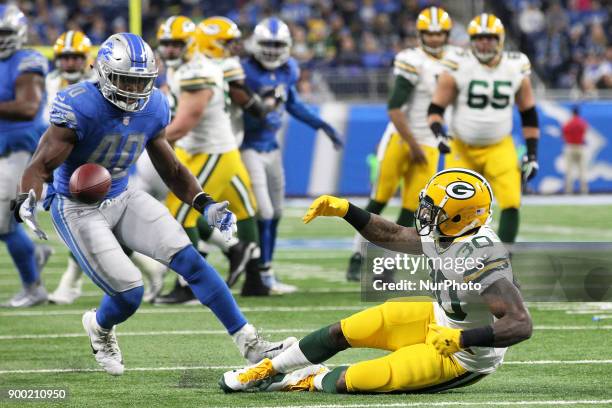 Detroit Lions linebacker Jarrad Davis recovers a fumble during the first half of an NFL football game against the Green Bay Packers in Detroit,...