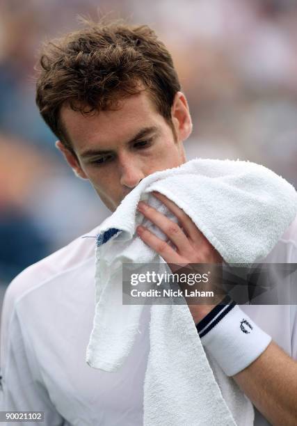 Andy Murray of Great Britain wipes sweat from his face in his semi final loss to Roger Federer of Switzerland during day six of the Western &...