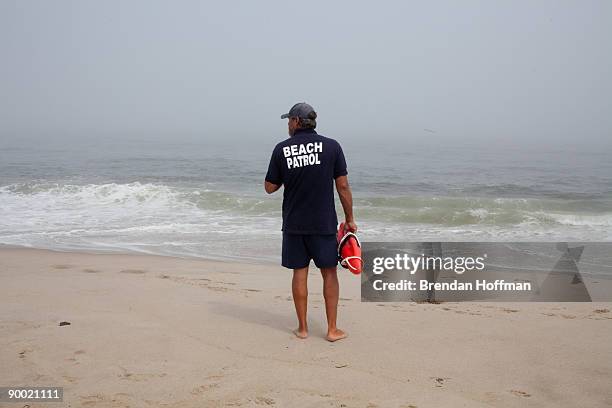 Beach Supervisor Vince Gulotta of the Chatham Harbormaster enforces a ban on swimming at Lighthouse Beach on August 22, 2009 in Chatham,...