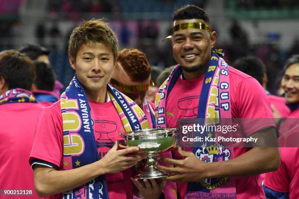 Yoichiro Kakitani and Ricardo Sandos of Cerezo Osaka hold the Emperor's Cup during the 97th All Japan Football Championship final between Cerezo...