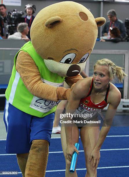 Verena Sailer of Germany celebrate winning the bronze medal with mascot Berlino in the women's 4x100 Metres Relay during day eight of the 12th IAAF...