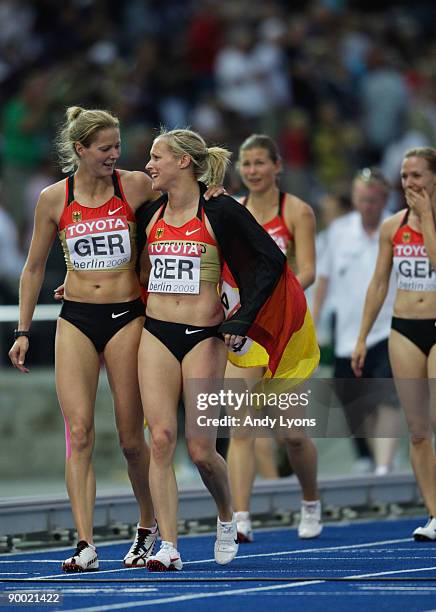 Marion Wagner Anne Möllinger Cathleen Tschirch Verena Sailer of Germany celebrate winning the bronze medal with mascot Berlino in the women's 4x100...